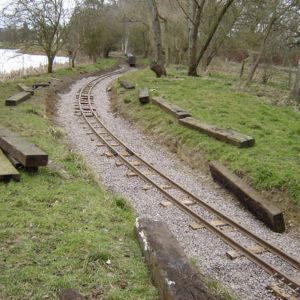 Three weeks later on a dry Saturday in March, and the ballasting to full depth is completed and track aligned and then cross level checked before final tamping and further ballasting. Restraining spike posts are also hammered in on the outer radius edge of each main joint sleeper in order to maintain alignment under train cornering forces on the curves.